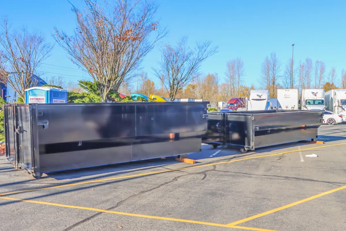 Professional dumpster rental service with roll-off container on residential driveway in Osage Beach